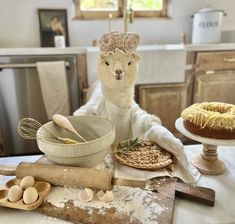 a table topped with cakes and doughnuts on top of wooden spoons next to an oven