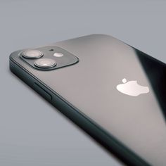 an apple phone with three buttons on the front and back side, sitting next to each other