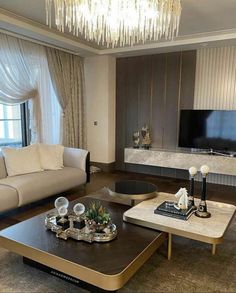 a living room filled with furniture and a flat screen tv on top of a wooden table