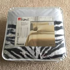 the coverlet is in zebra print with black and white stripes