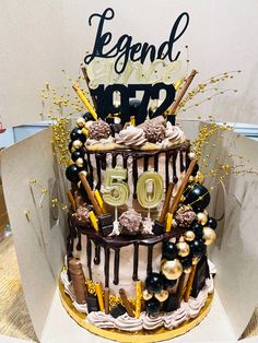 a 50th birthday cake with chocolate and gold decorations