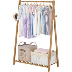 a wooden rack with clothes hanging from it's sides and a basket on the other side