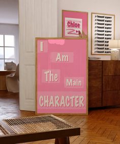 a pink sign that says i am the main character next to a wooden bench in a room