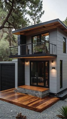 a modern house with wood decking in the front yard