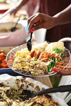 two people are serving themselves food from plates