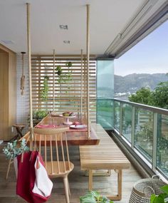 a wooden bench sitting on top of a hard wood floor next to a table and chairs