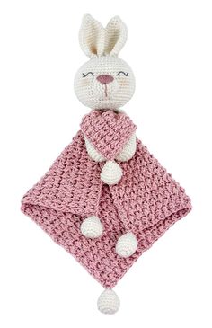 a crocheted bunny holding a pink blanket