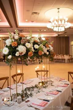 the centerpieces are decorated with flowers and candles