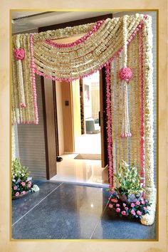 an entrance decorated with pink and white flowers