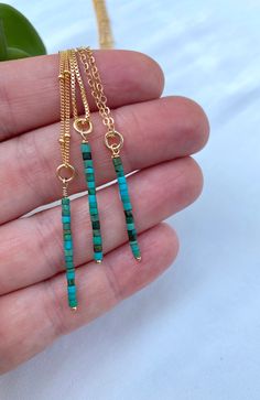 **Each piece in my shop, I personally create and photograph. (All photos are property of The Cord Gallery LLC) Thank you for supporting my small business. Features dainty, Raw Turquoise Heishi Beads Hand wrapped on a 14k Gold Filled wire connector to create a vertical bar charm. The perfect stand alone or layering piece. Each pendant will be similar yet unique as these are all natural gemstones. Turquoise is one of December's birthstones, so these make the perfect gift!Hangs on your choice of ch Bead Bar Necklace, Raw Turquoise, Bead Bar, Vertical Bar, Beaded Pendant Necklace, Heishi Beads, December Birthstone, Bar Necklace, Beaded Pendant