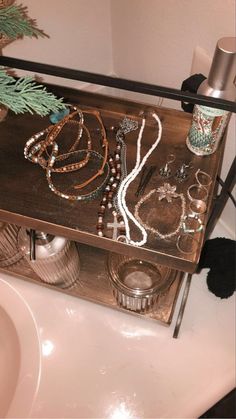 a wooden shelf with jewelry on top of it