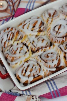 a pan filled with cinnamon rolls on top of a table