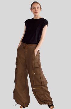 Houndstooth cargo pants Relaxed fit with drawstring waist Elastic drawstring hem with gold hardware Side flap button pockets and side zip pockets D-ring gold metal accents Cowhide Pants, Brown Cargo Pants, Metal Accents, Cynthia Rowley, Metallic Accents, Ring Gold, D Ring, Drawstring Waist, Cargo Pants