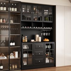 a kitchen with black cabinets and shelves filled with bottles, glasses, and other items