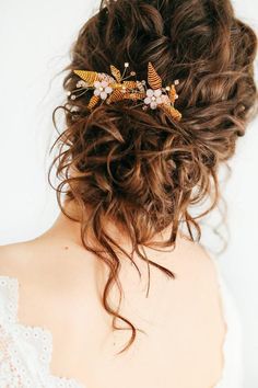 a woman wearing a hair comb with flowers on it