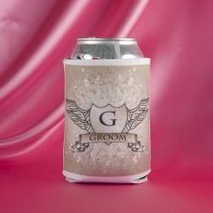 a can of beer on a pink background with wings and the letter b above it