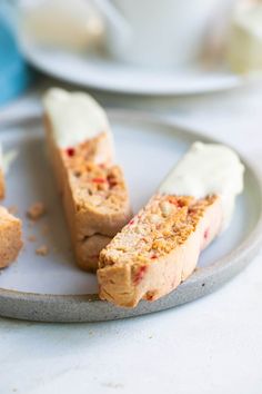 three pieces of cake on a plate with white icing and crumbs around them