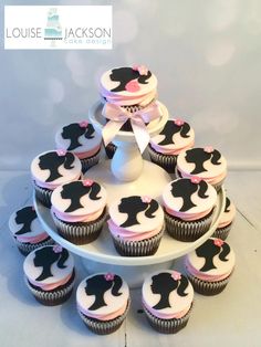 cupcakes are arranged in the shape of a woman's head on a cake stand