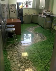 a kitchen with green grass on the floor