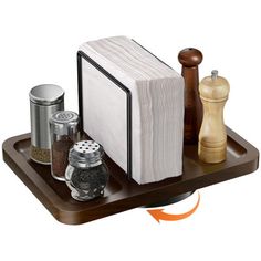 an open book sitting on top of a wooden tray next to salt and pepper shakers