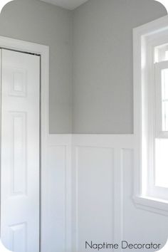 an empty room with white paint on the walls and a door in the corner next to it