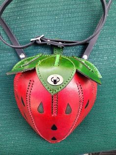 This is a very nice decorative leather Strawberry purse/ bag, all top grain Leather, Hand dyed red and green with black seeds, All handmade and stitched, opens from the top, has a twist closing clasp, Adjustable Strap with buckle 52'' to 56" in length. the purse measures 9 inches from the top to the bottom and 6.5 inches wide. the top has a opening of 4 inches wide x 3 inches and the purse is 7 inches deep tapered down to the point of the Strawberry, perfect for a cell phone, wallet and keys. Red Leather Pouch Coin Purse, Green Leather Coin Purse Pouch, Red Leather Coin Purse With Removable Pouch, Unique Leather Bag As A Gift, Green Leather Coin Purse For Gift, Kitsch Purse, Strawberry Purse, Strawberry Bag, Unusual Handbags