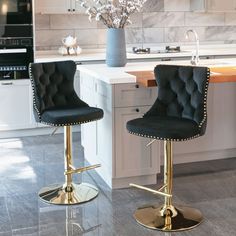 two black and gold bar stools in a kitchen