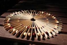 a wooden fan sitting on top of a table