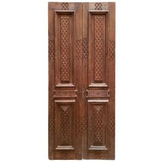 two wooden doors with intricate carvings on them