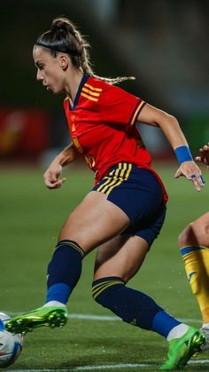 two women are playing soccer on the field