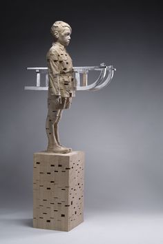 a sculpture of a man holding a tray