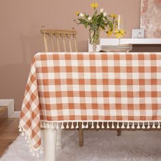 a dining room table covered with a checkered tablecloth