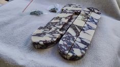 two pieces of marble sitting on top of a white towel