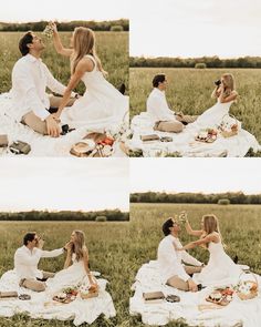 two people sitting on a blanket in the middle of a field eating food and drinking wine