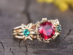 Ruby Art Nouveau Engagement Ring Vintage Flower Wedding Ring Emerald Floral Ring Unique Promise Ring 14K Yellow Gold Moissanite Halo 1.5CT Main ring: Solid 14K 18K Rose Gold yellow gold white gold 8mm Round Cut Lab Red Ruby, total weight about 1.5ctw 3mm Round Cut Lab Emerald on each side 0.12ctw Round Cut Classic Moissanites band width(bottom) approx 3.2mm Top : 11mm wide, The height of setting:6.5mm Prong Set Jewelry maintenance tips ▶ To avoid of chemical reactions,do not touch with daily che Flower Shaped Wedding Ring With Accent Stones, Wedding Ruby Ring With Moissanite Accent Stones, Red Flower-shaped Ring For Wedding, Red Flower Shaped Wedding Ring, Wedding Red Flower Shaped Ring, Wedding Red Flower-shaped Ring, Vintage Flower Wedding, Red Engagement Ring, Ruby Engagement Ring Vintage