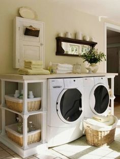 a white washer sitting next to a dryer in a room