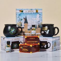 the harry potter mugs are on display in front of their boxes and packages for sale