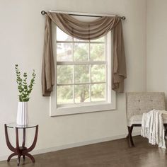 a living room with a chair, table and window