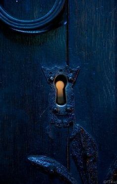 an open door with a light in the middle and a keyhole on the side