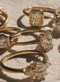 several gold rings with assorted diamonds on them