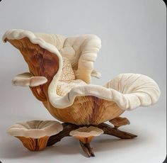 a mushroom like chair and footstool made out of wood