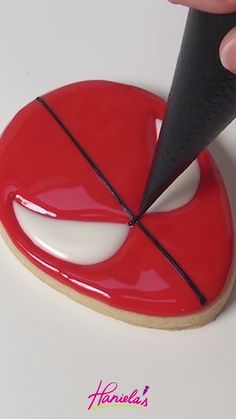 a person is cutting into a cookie with a sharpie knife on the top and bottom