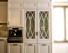 a kitchen with white cabinets and an oven