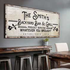 an old fashioned sign is hanging on the wall above a bar and dining room table