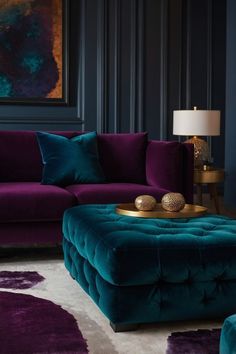 a living room with purple and green furniture in the corner, including a large ottoman