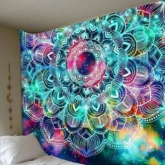 a colorful wall hanging over a bed in a bedroom