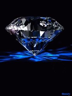 an image of a diamond in the dark with blue light coming from its center and behind it