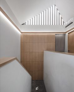 the interior of an office building with wood and white walls