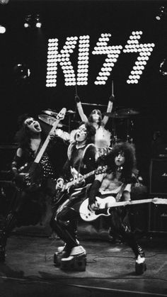 the kiss band performing on stage with their guitars