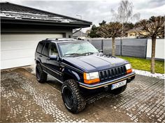 a jeep parked in front of a garage